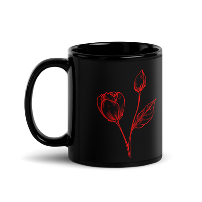 Black mug with red rose design on a white background