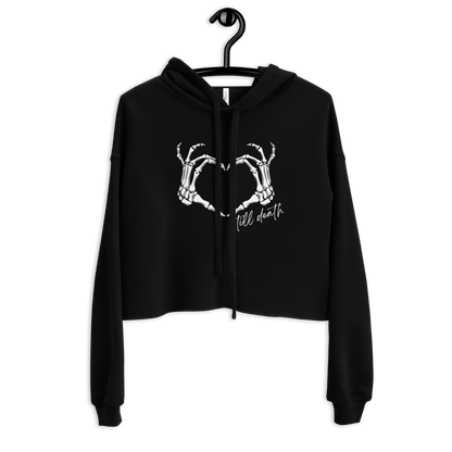 Black hoodie with skeleton hands in a heart formation then says till death design on a hanger against a white background